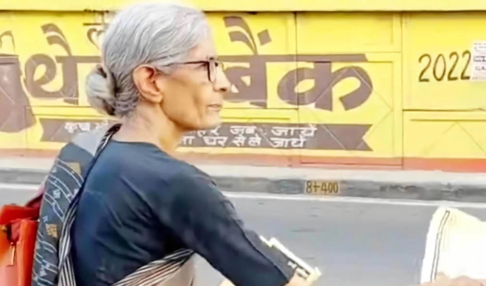 Prof. Roop Rekha Verma distributes pamphlets on the streets of Lucknow, India, in July 2022, calling for the revival of the unity spirit of the 1857 Revolt. (Roop Rekha Verma)