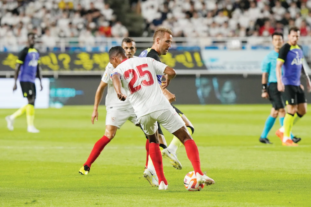 Tottenham Hotspur’s Harry Kane fights for the ball with Sevilla FC’s Fernando during their pre-season soccer match on Saturday at Suwon World Cup Stadium in Suwon, South Korea. (AP)