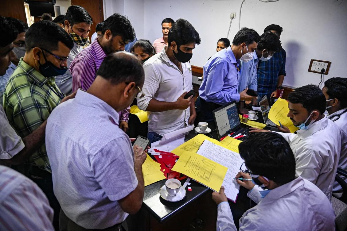 People queue up to get themselves registered for a booster dose of a vaccine against the Covid-19 coronavirus at a vaccination camp in New Delhi on July 15, 2022. (AFP)