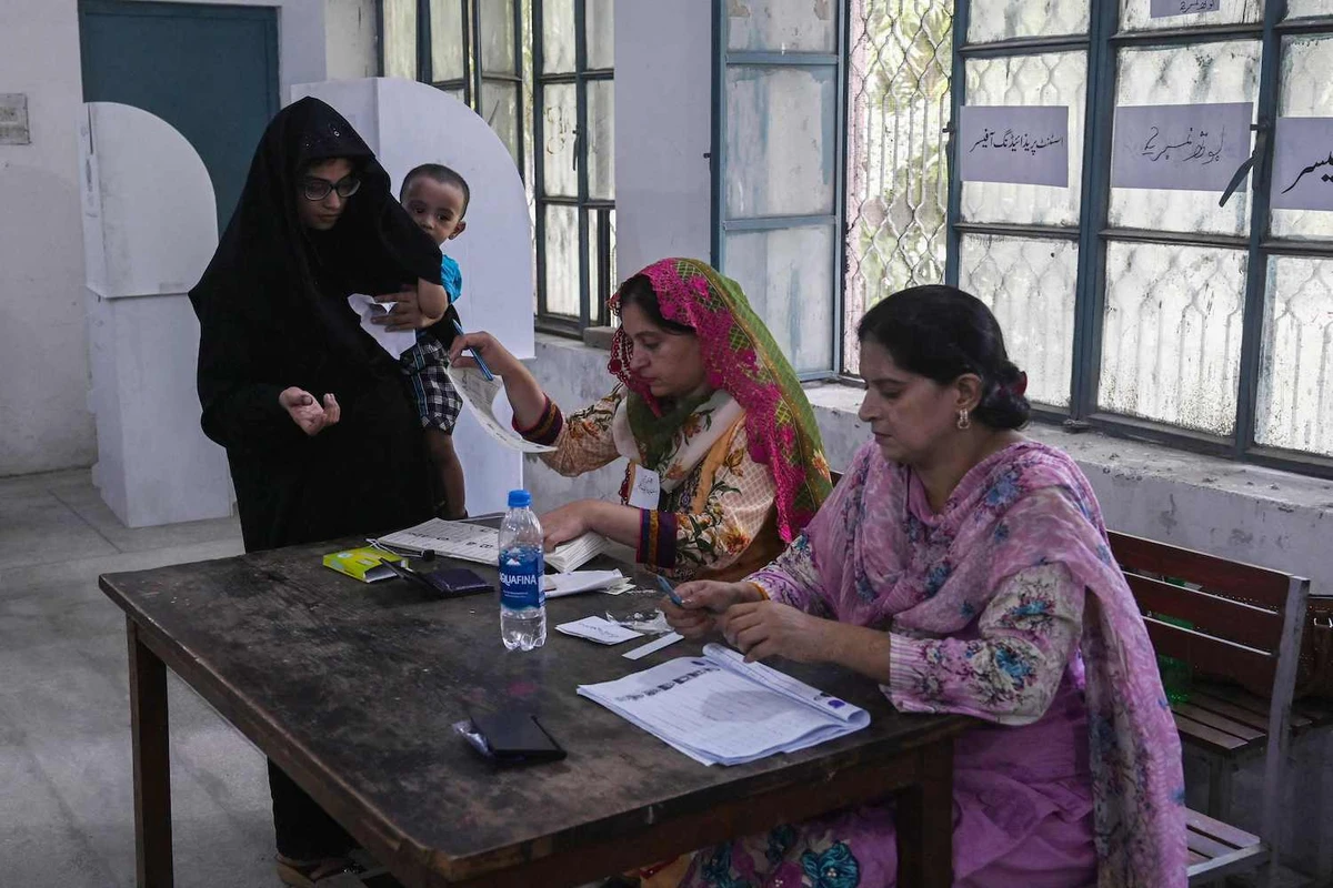 A voter arrives to cast her ballot at a polling station during the by-election in Punjab province assembly seat in Lahore on July 17, 2022. (AFP)