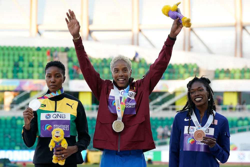 Gold medalist Yulimar Rojas, of Venezuela, center, with silver medalist Shanieka Ricketts of Jamaica, left, and bronze medalist Tori Franklin of the US during a medal ceremony for women’s triple jump at the World Athletics Championships on Monday. (AP)