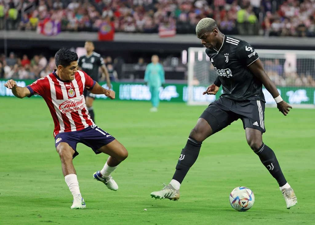 Jesús Sánchez of Chivas defends against Paul Pogba of Juventus during their preseason friendly match at Allegiant Stadium on Friday in Las Vegas, Nevada. (AFP)
