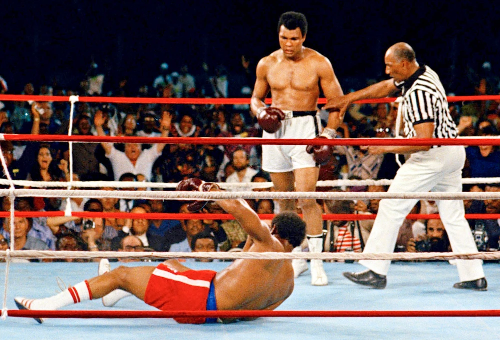 Referee Zack Clayton steps in after challenger Muhammad Ali knocked down defending heavyweight champion George Foreman in the eighth round of their championship bout on Oct. 30, 1974, in Kinshasa, Zaire. (AP)