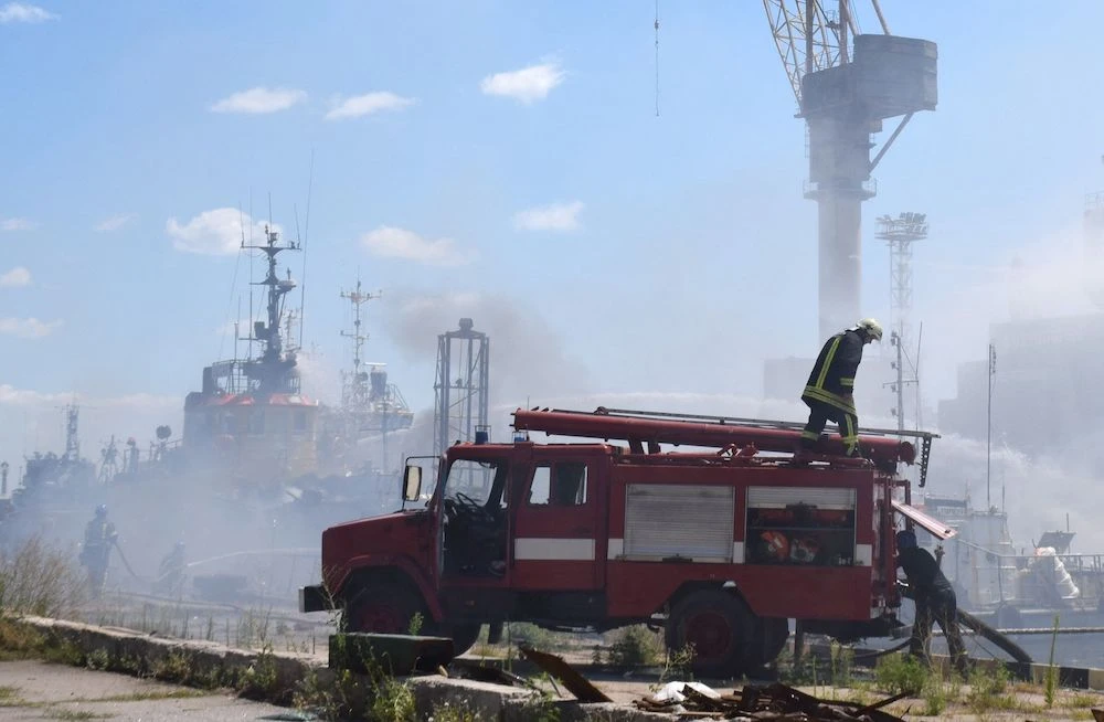 Firefighters battle a fire on a boat in the port of Odessa after missiles hit the port on July 23, 2022. (Odessa City Council Telegram via AFP)