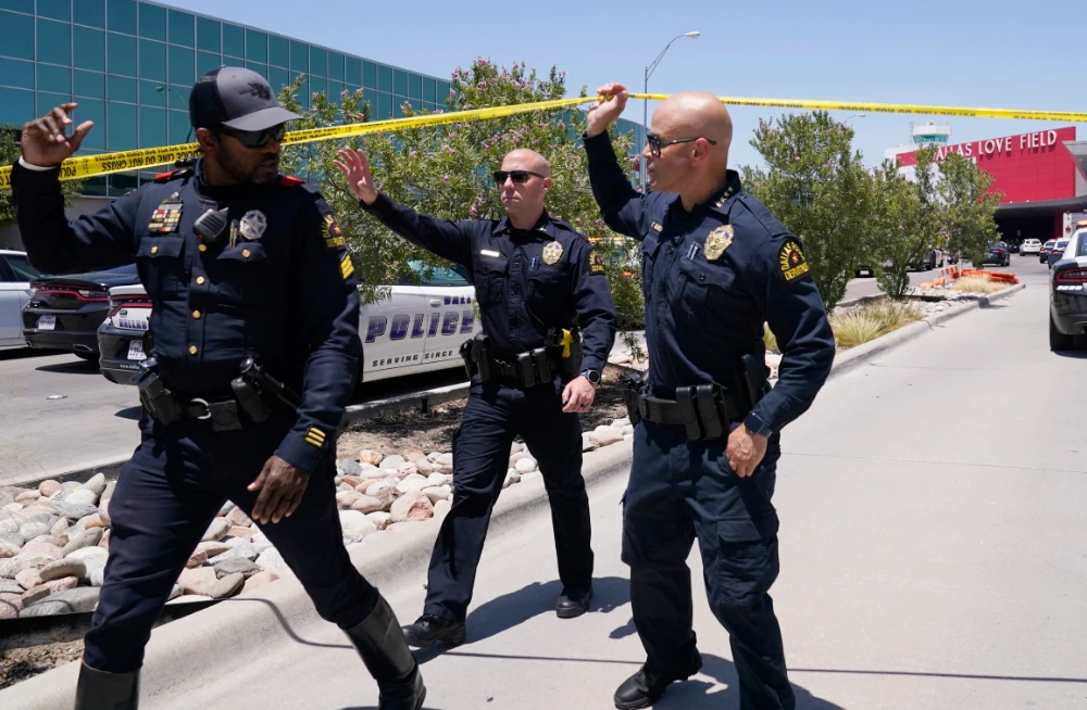 Dallas Chief of Police, Edgardo Garcia, right, and two other officers depart Dallas Love Field in Dallas, Monday, July 25, 2022. (AP)