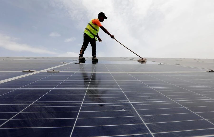 A worker cleans solar cells on the roof of a hotel in the resort town of Sharm el-Sheikh as the city prepares to host the COP27 summit in November, Sharm el-Sheikh, Egypt, June 4, 2022. (Reuters)