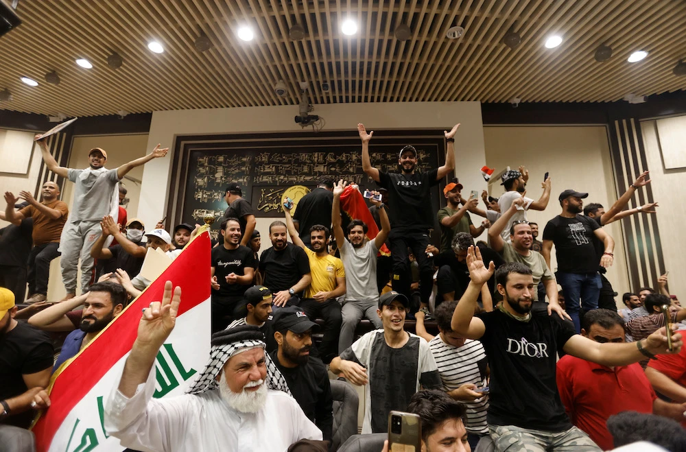 Supporters of Iraqi Shiite cleric Moqtada Al-Sadr protest against corruption inside the parliament building in Baghdad, Iraq July 27, 2022. (Reuters)