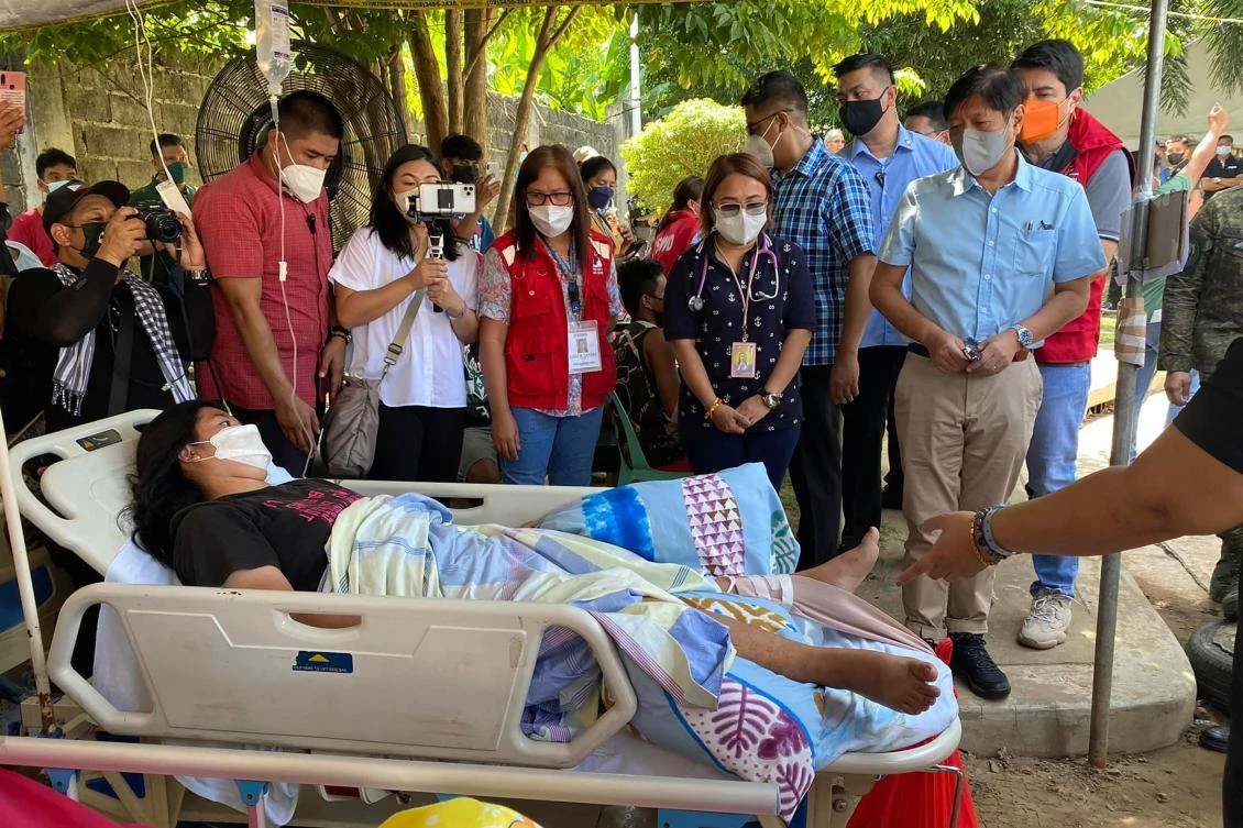 Philippine president Ferdinand Marcos Jr., front right, visits hospital patients evacuated to the grounds of the provincial hospital in Bangued town, Abra on July 28, 2022. (Irelee Beralde via AFP)