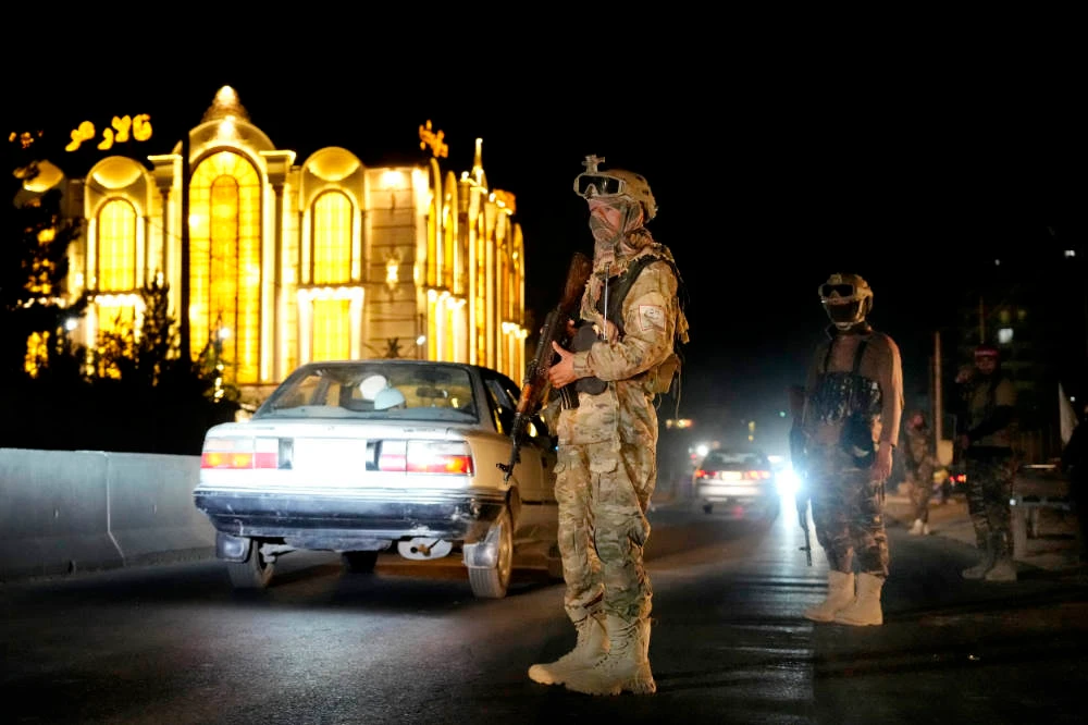 Taliban fighters stand guard at the site of an explosion in front of the Kabul International Cricket Stadium, in Kabul, Afghanistan, Friday, July 29, 2022. (AP)