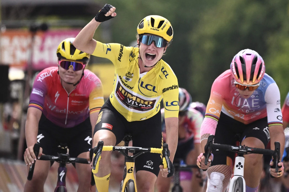 Team Jumbo Visma's Dutch rider Marianne Vos (C) celebrates as she crosses the finish line to win the 6th stage of the new edition of the Women's Tour de France cycling race on July 29, 2022. (AFP)