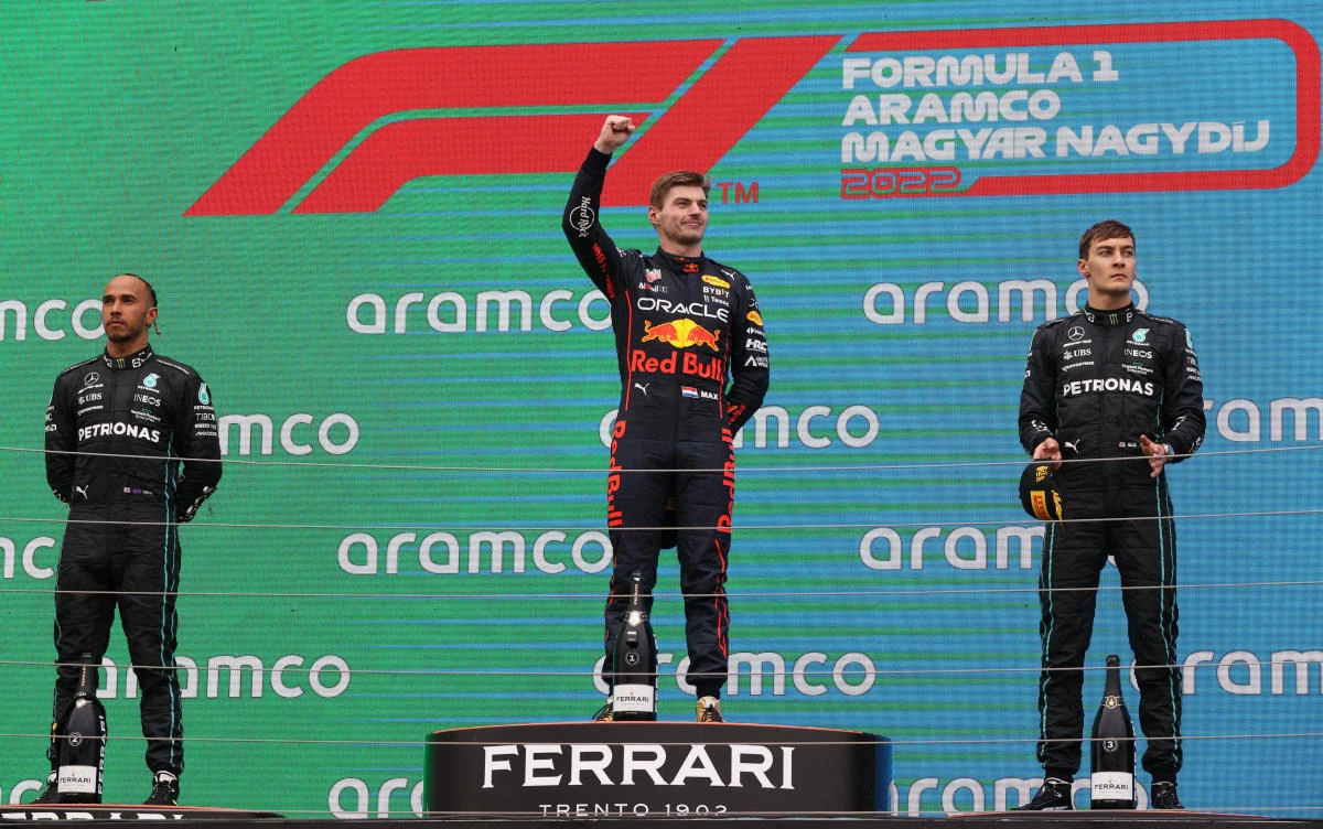Red Bull's Max Verstappen celebrates after winning the Hungarian Grand Prix alongside Lewis Hamilton, left, and George Russell, Hungaroring, Budapest, Hungary, July 31, 2022. (Reuters)