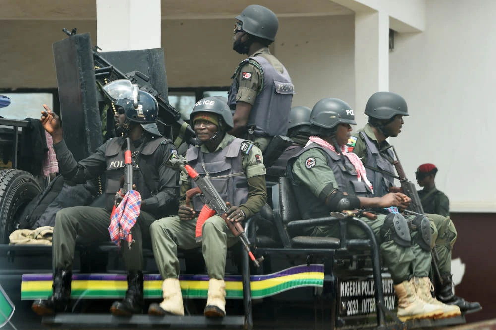 Police men sit on a truck as they patrol in Akwa, Anambra State in southeast Nigeria. (AFP)