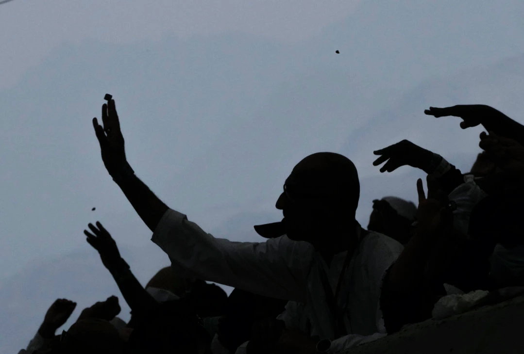 Muslim pilgrims cast stones in the symbolic stoning of the devil ritual during the Hajj pilgrimage, in Mina. (AP)