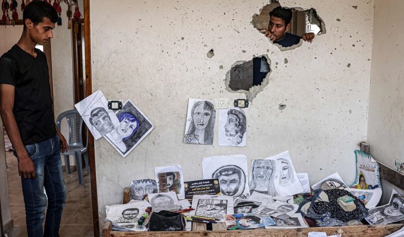 The brothers of 22-year-old Palestinian artist Diana Al-Amour, who was killed in an Israeli airstike, Gaza, Aug. 10, 2022. (AFP)