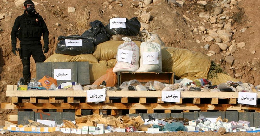 A security force member stands next to seized drugs that are about to be burned in Erbil, Iraqi Kurdistan, Oct. 29, 2013. (AFP)