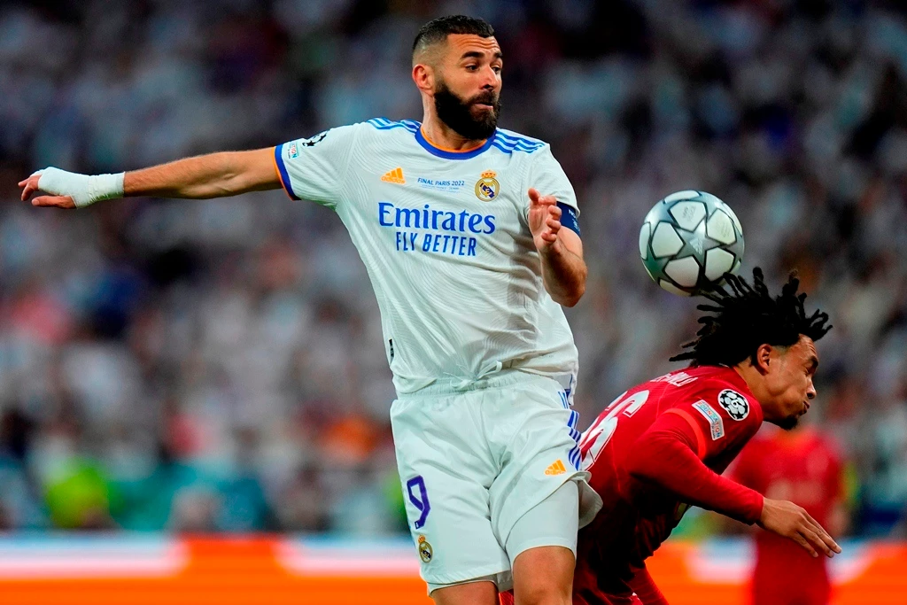 Real Madrid's Karim Benzema jumps for a header with Liverpool's Trent Alexander-Arnold during their Champions League final match at the Stade de France in Saint Denis near Paris, on May 28, 2022. (AP/File)