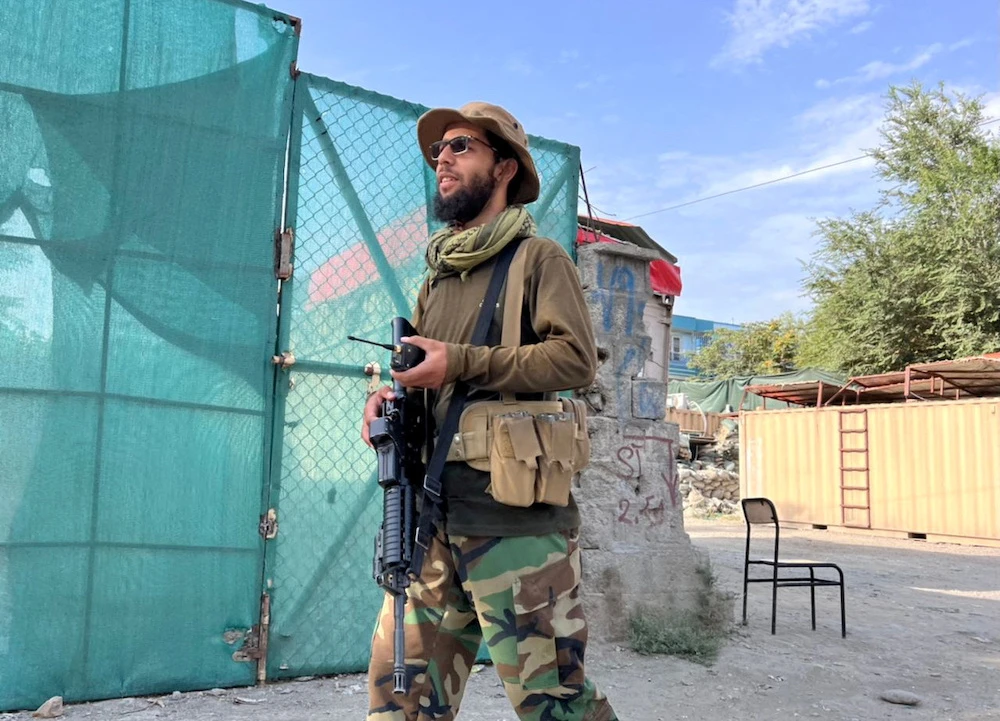 Above, a Taliban fighter stands guard near the site where Al-Qaeda leader Ayman Al-Zawahiri was killed in a US strike over the weekend in Kabul, Afghanistan. (Reuters)