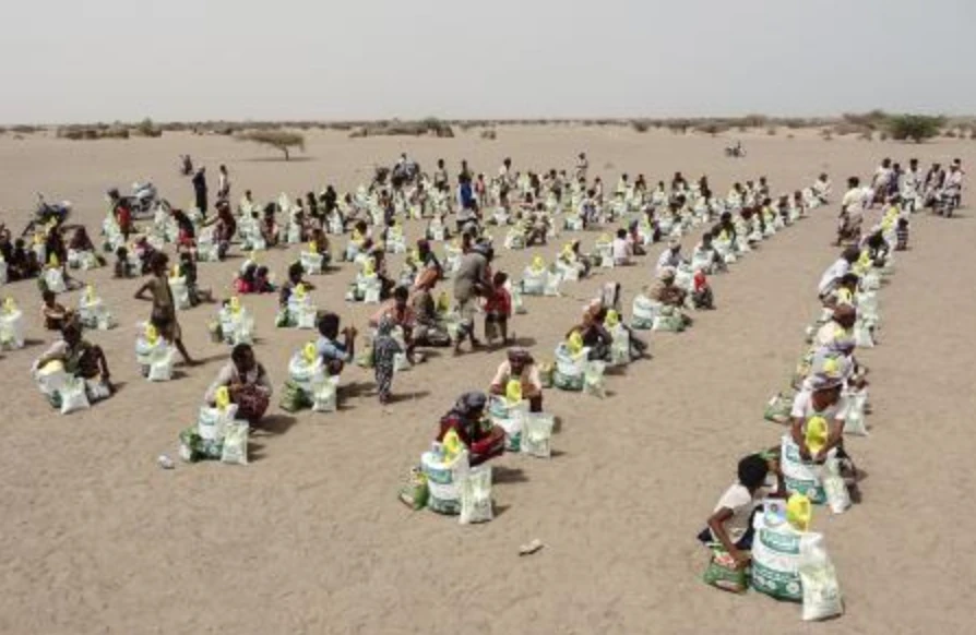 In this file photo taken on July 6, 2022, Yemenis displaced by the conflict receive aid and supplied at a camp in Hays district in the war-ravaged western province of Hodeidah. (AFP)