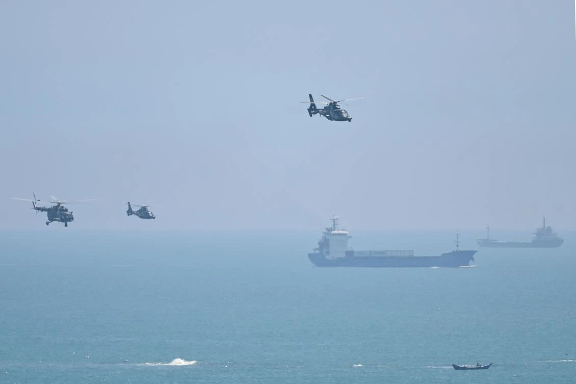 Chinese military helicopters fly past Pingtan island, one of mainland China’s closest point from Taiwan, in Fujian province on Aug. 4, 2022, ahead of massive military drills. (AFP)