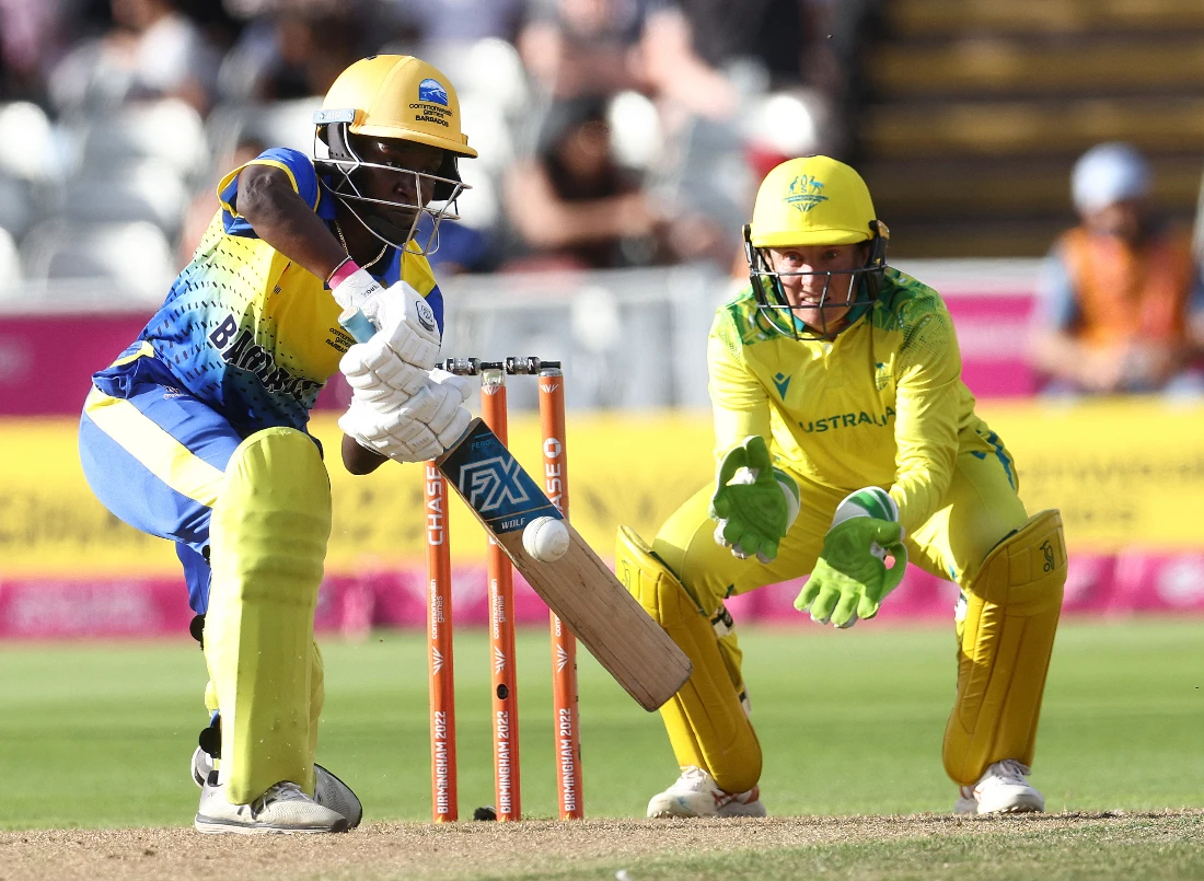 Barbados' Kycia Knight (L) plays a shot away from Australia's Alyssa Healy (R) during the women's Twenty20 Cricket match between Australia and Barbados. (AFP)