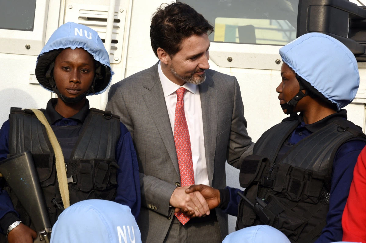 In this Feb. 13, 2020 photo, Canadian Prime Minister Justin Trudeau talks with female soldiers in Colobane, Senegal during his visit to the African country. (AFP file)