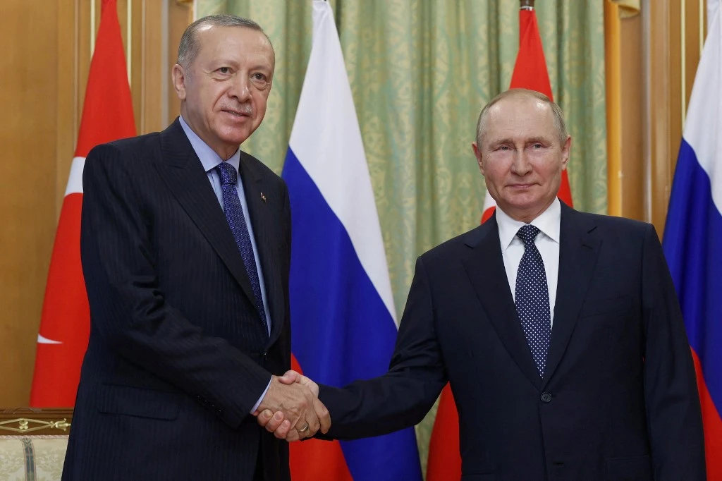 Russia's President Vladimir Putin (R) shaking hands with Turkish President Recep Tayyip Erdogan (L) in Sochi. AFP