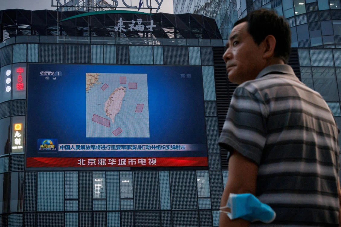 Above, a news broadcast features locations around Taiwan where China is conduct military exercises. (Reuters)