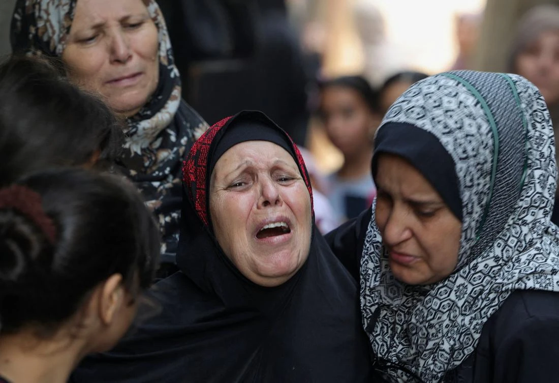 Relatives mourn during the funeral of four teenage Palestinians from the Najm family in Jabalia in the northern Gaza Strip on August 8. (AFP)
