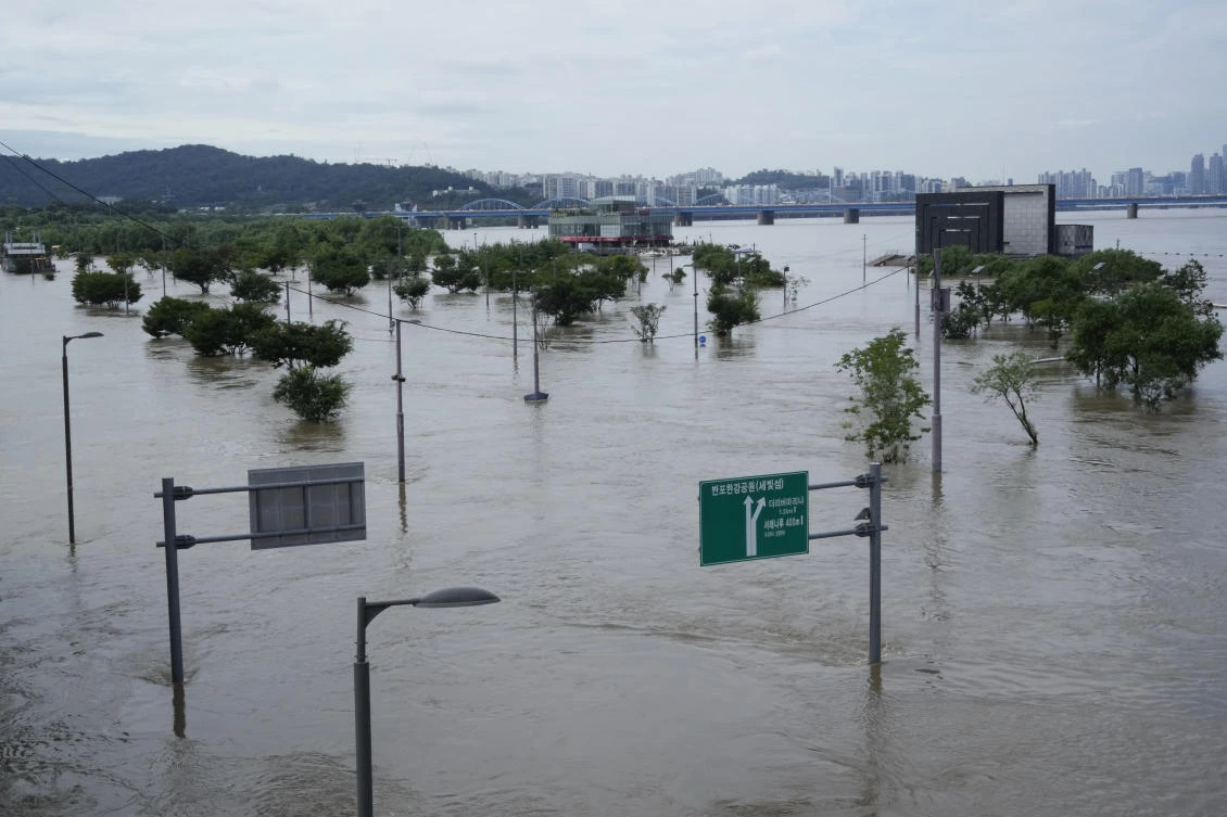Two days of record-breaking rainfall unleashed flash floods, damaged thousands of buildings and roads and killed at least nine people. (AP)