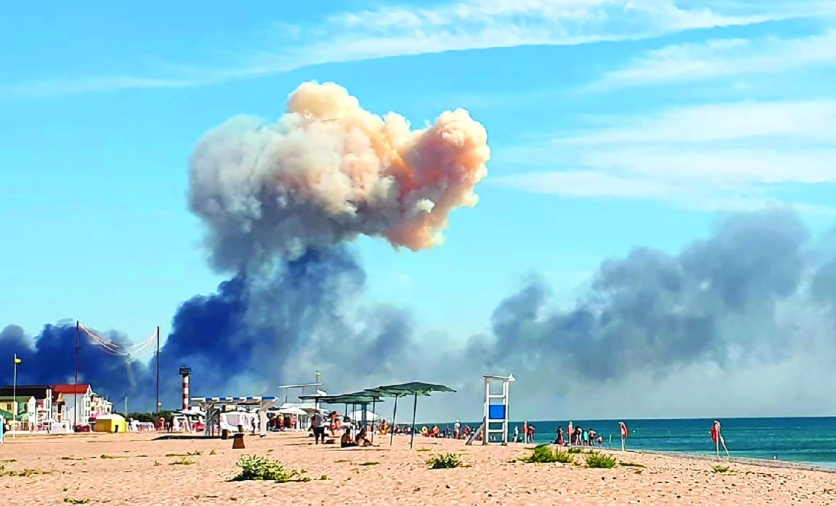 Rising smoke can be seen from a beach at Saki Air Base after explosions were heard from the direction of a russian airbase near Novofedorivka, Crimea. (AP)