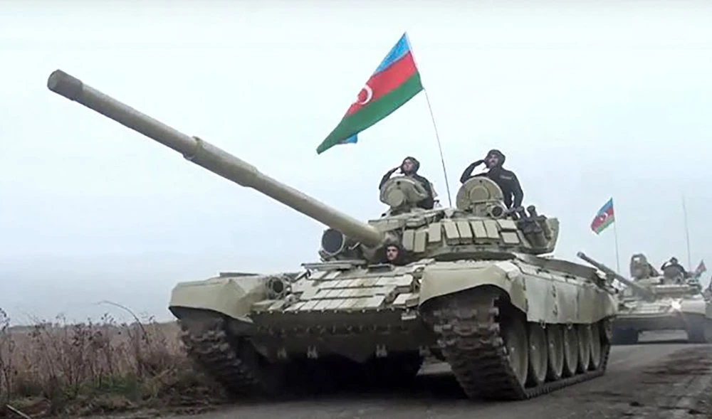 Azerbaijani tanks running along a road as Azerbaijan army units enter the Aghdam region of Nagorno-Karabakh. (AFP file photo)