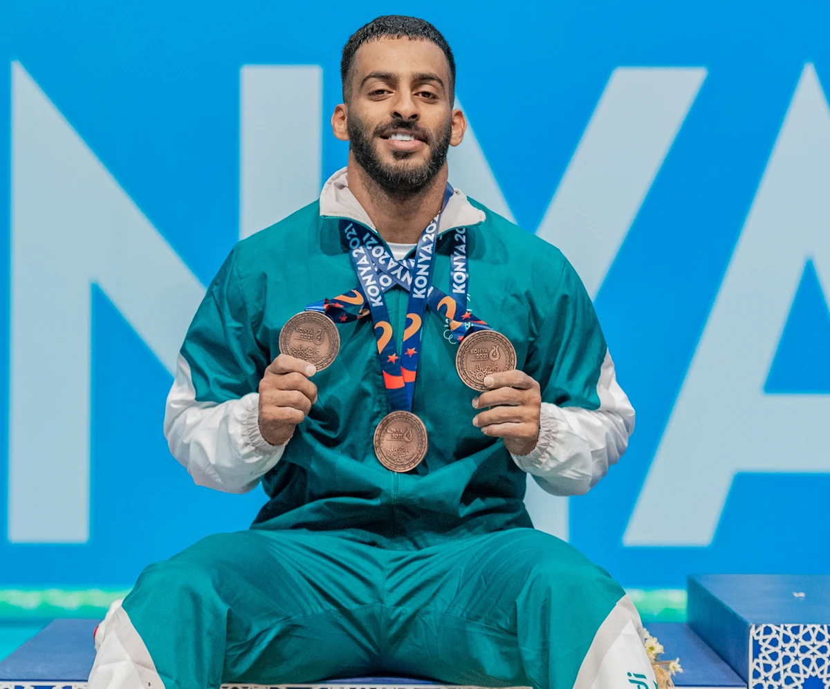 Saudi's Abdulrahman Al-Biladi with his three bronze medals from the weightlifting comeptition. (@saudiolympic)