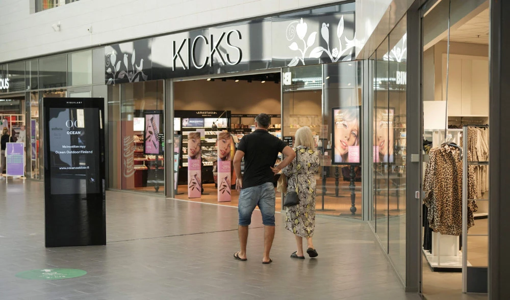 A man and a woman believed to be Russian tourists walk inside a shopping center in Lappeenranta, Finland on August 12, 2022. (AFP)