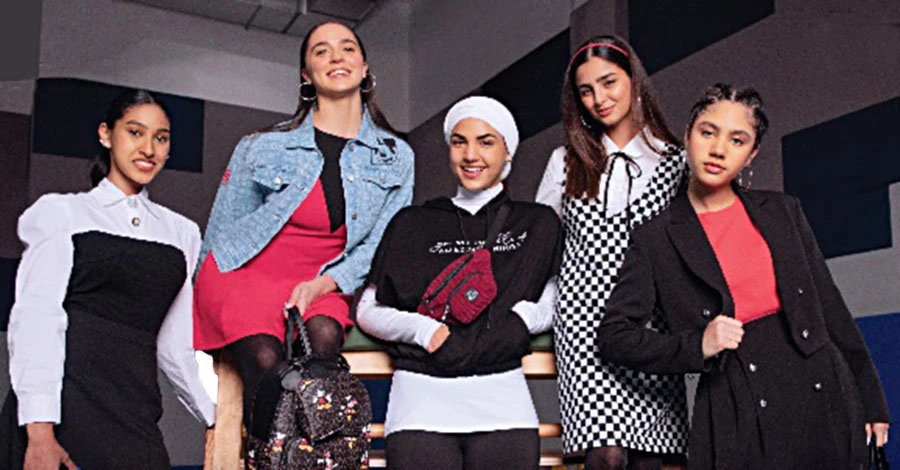 Comfy essentials anchor the collection that has a mix of denim, casual tees, varsity jackets, skirts, formal pieces, and backpacks.