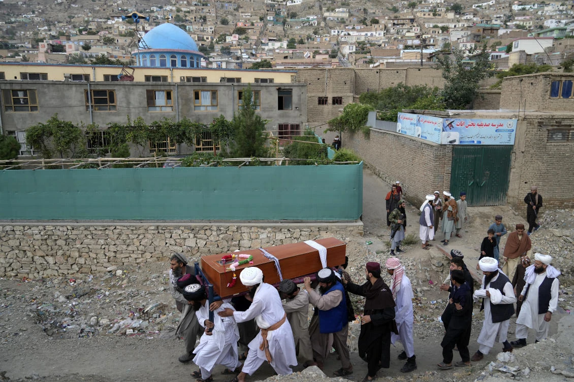 Mourners carry the body of a victim of a mosque bombing in Kabul on Aug. 18. 2022. (AP)
