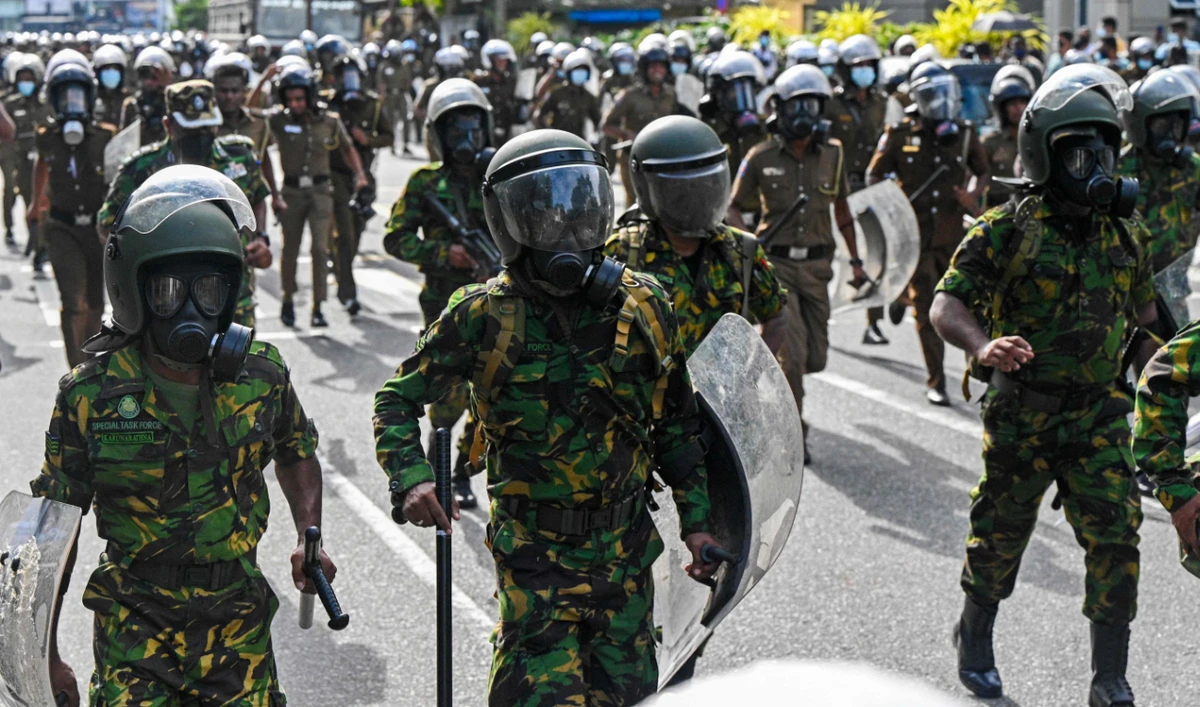 Policemen stand guard during a demonstration by the university students in Colombo on August 18, 2022. (AFP/File)