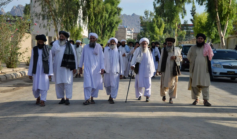 Taliban religious scholars leave after attending a public meeting on economic welfare at a private salon in Kandahar on August 18, 2022. (AFP)
