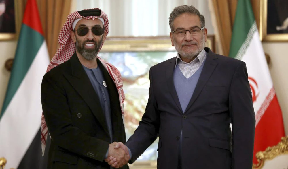 Secretary of Iran's Supreme National Security Council Ali Shamkhani, right, and United Arab Emirates' top national security adviser Sheikh Tahnoon bin Zayed Al Nahyan shake hands prior to their meeting in Tehran, Iran on December 6, 2021. (AP/File)