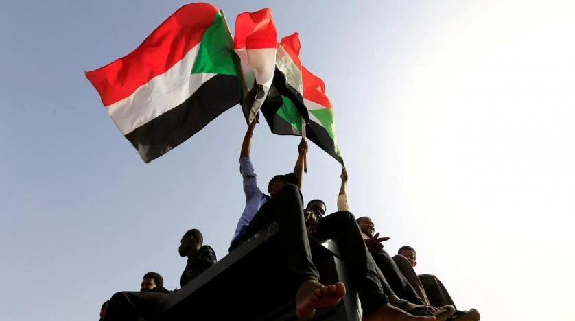 Sudanese protesters wave flags during a rally honoring fallen protesters at the Green Square in Khartoum, Sudan July 18, 2019. (Reuters)
