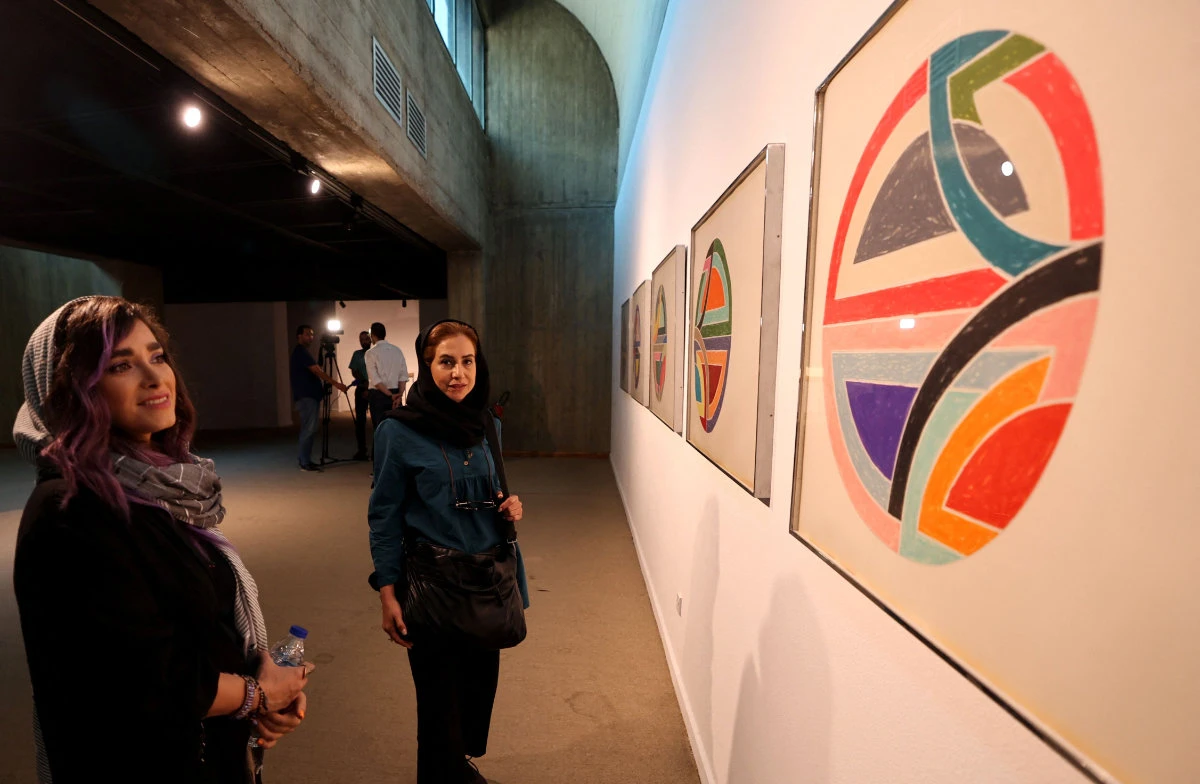Visitors take a look at artwork by American artist Sol LeWitt being exhibited at the Tehran Museum of Contemporary Art in Tehran on August 22, 2022. (AFP)
