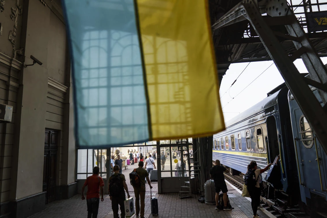 The flag of Ukraine hangs in a train station as passengers arrive in Lviv, Ukraine, on the country’s Independence Day, on Wednesday. (AP)