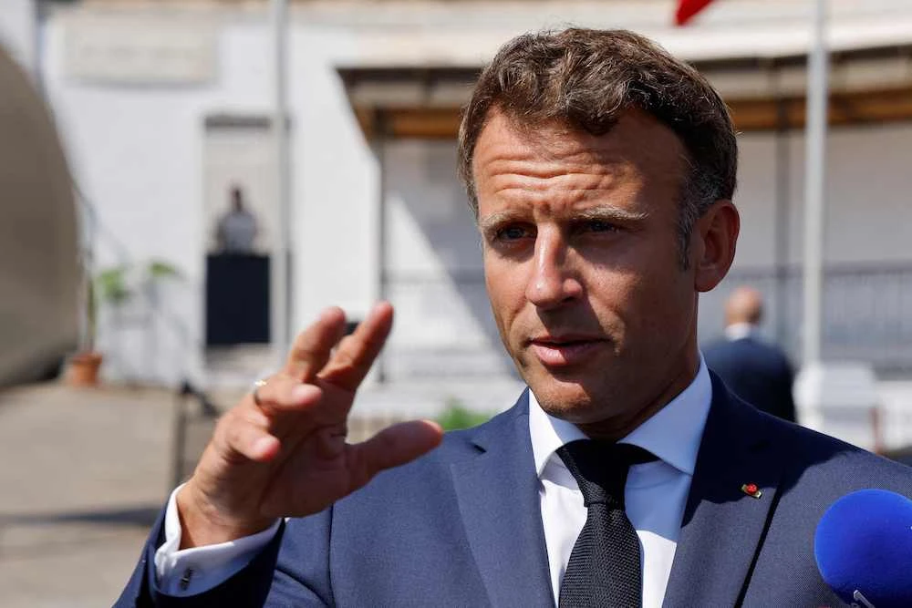 French President Emmanuel Macron speaks to the press after a visit to the European Saint-Eugene Cemetery in Algiers during a three-day visit to Algeria aimed at mending ties with the former French colony. (AFP)