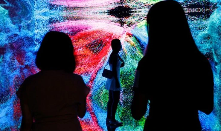 Visitors are pictured in front of an immersive art installation at the Digital Art Fair, Hong Kong, Sept. 30, 2021. (Reuters)