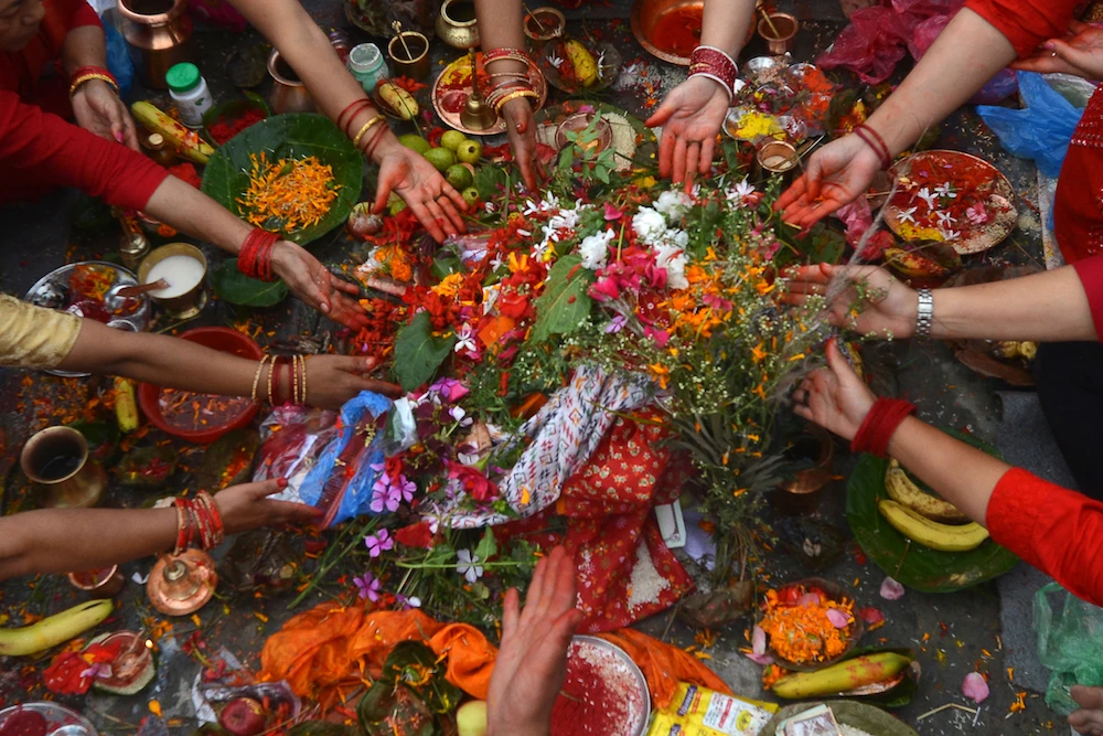 Hindu devotees offer prayers on the banks of the Bagmati River on the occasion of Rishi Panchami at the end of the three-day long Teej Festival, in which Hindu women fast during the day and pray for the long lives for their husbands. (AFP)