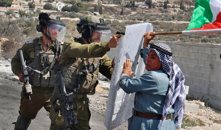 A Palestinian demonstrator confronts Israeli security forces following a protest in the occupied West Bank. (AFP)