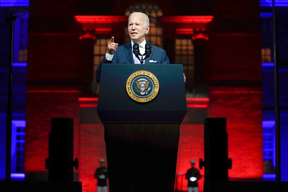 Biden spoke in Philadelphia from behind bullet-proof glass and within earshot of chanting Trump-supporting protesters. (AP)