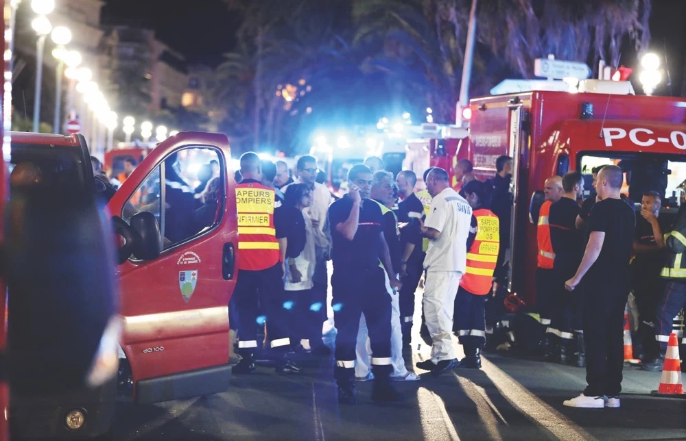 Police officers, firefighters and rescue workers work at the site of the terror attack on the Promenade des Anglais in Nice on July 14, 2016. The trial of the accused is scheduled to start on Monday. (AFP/File)