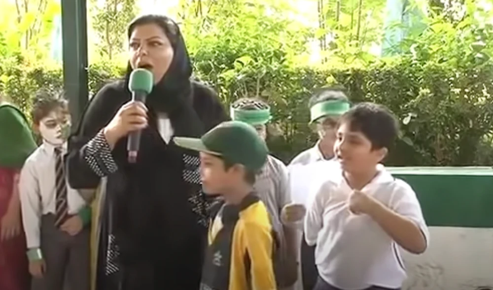 In this screenshot, Sehar Kamran, dressed in black, was handing microphones to children at the Pakistan International School Jeddah during an event in 2010. (Photo courtesy: Ammar Yasir/Youtube)