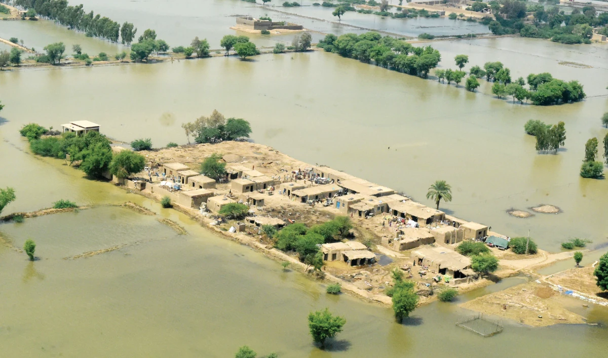 This aerial photograph taken on Saturday shows flood-affected people as they gather outside their damaged houses in Jaffarabad district, Balochistan province. (AFP)