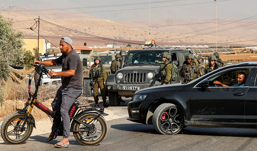 Israeli soldiers enforce the closure of a road near the site of an attack on an Israeli bus east of the Palestinian city of Tubas in the north of the occupied West Bank on September 4, 2022. (AFP)